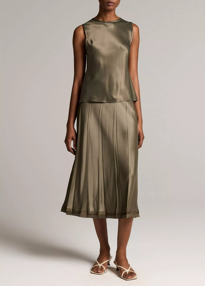 CREASED PLEATED SKIRT W/ RAW EDGE HEM